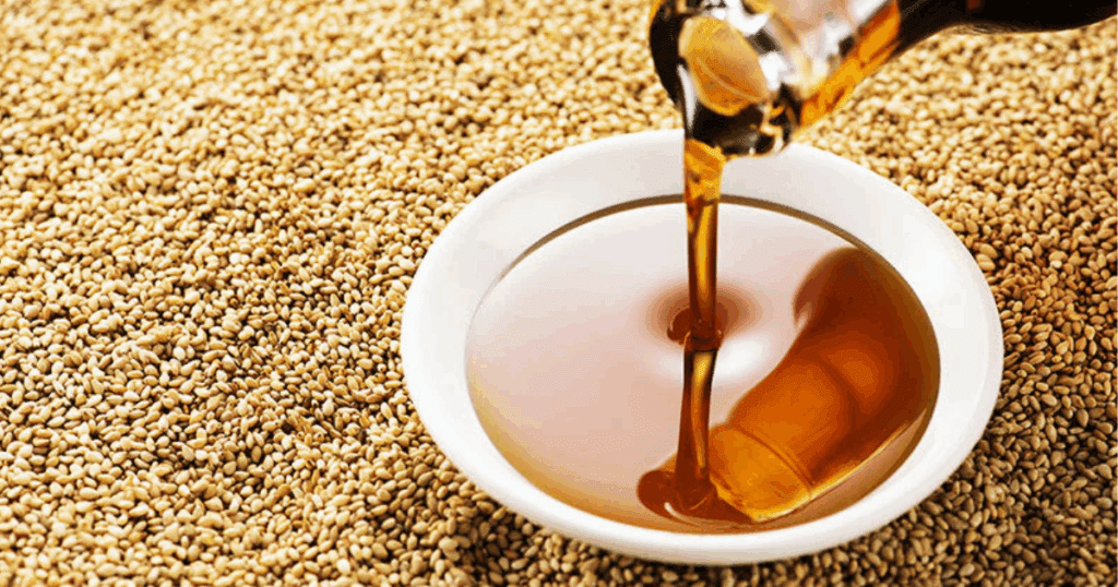 Bottle of sesame oil with sesame seeds highlighting its aroma and cooking benefits