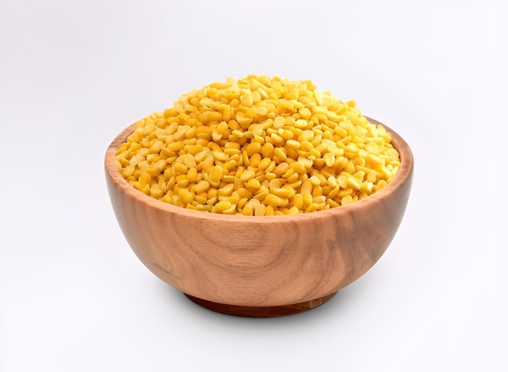Assorted lentils in bowls on a wooden kitchen counter