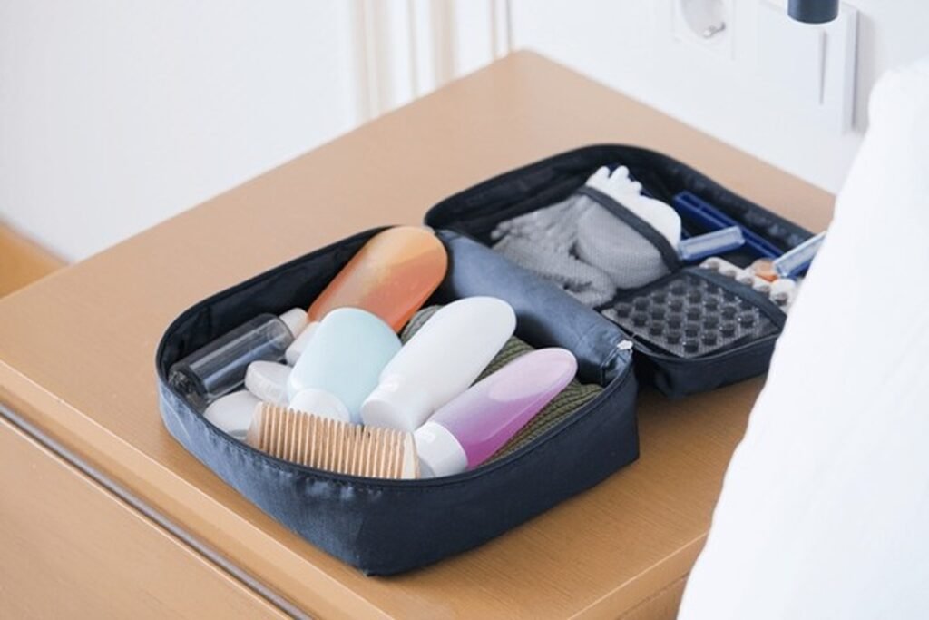 Travel toiletry kit with personal care essentials like tissues, wipes, sanitizer, and grooming items