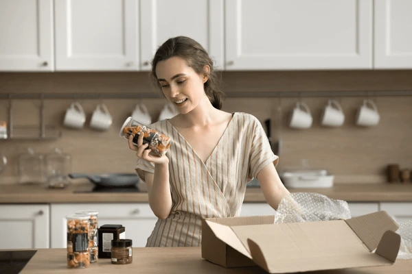 Fresh grocery delivery boxes being opened and stored properly in a Dubai apartment kitchen